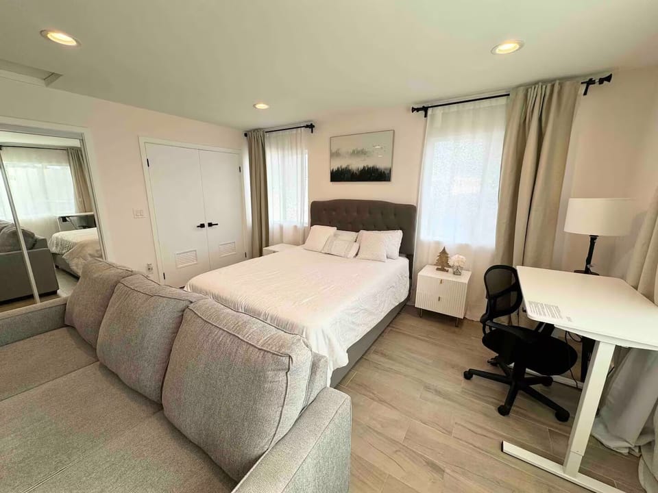 Open concept studio with queen bed and dedicated workstation.
