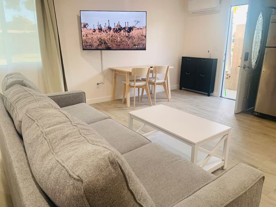 Dining area with 65 inch 4K Smart TV.
