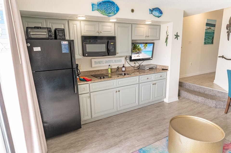 - A bright and inviting kitchen with coastal-inspired accents and modern appliances - Plenty of storage, counter space, and natural light make this a perfect spot for meal prep - Designed for convenience, so you can spend more time enjoying the beach