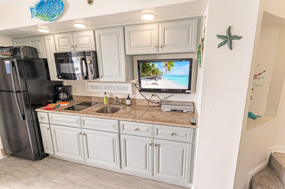 - Functional kitchen with everything you need for a comfortable stay - Sleek cabinetry, granite countertops, and modern appliances bring convenience to your beachside retreat - Whip up a quick meal or brew fresh coffee while enjoying the ocean breeze