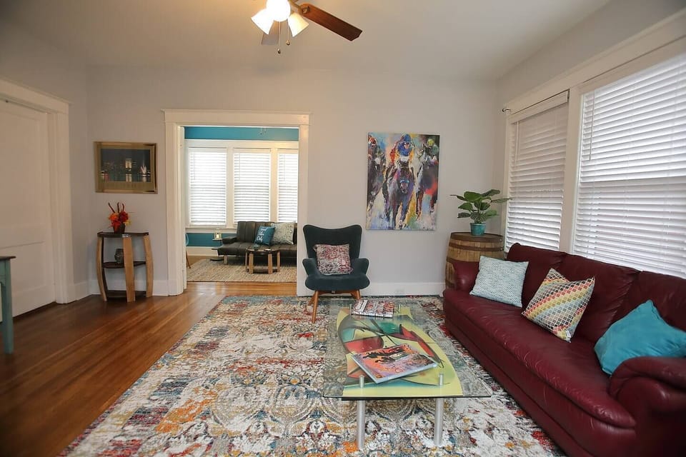 Living room and sunroom offer options for guest seating.