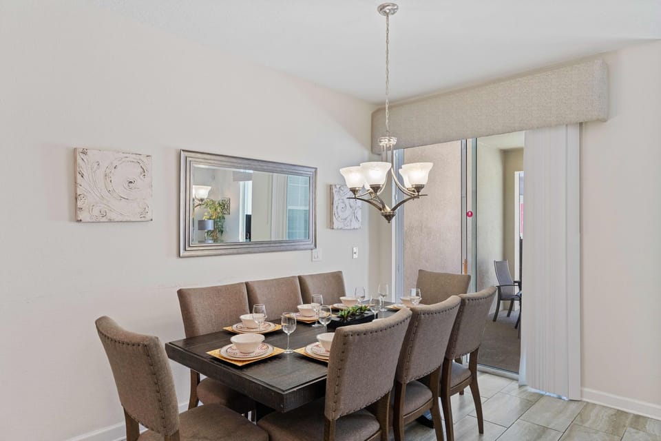 Sleek dining area of the town house in Kissimmee Florida - 8 Persons Dining - Sophisticated design with a blend of modern and classic elements - Intimate ambiance created through soft, lighting
