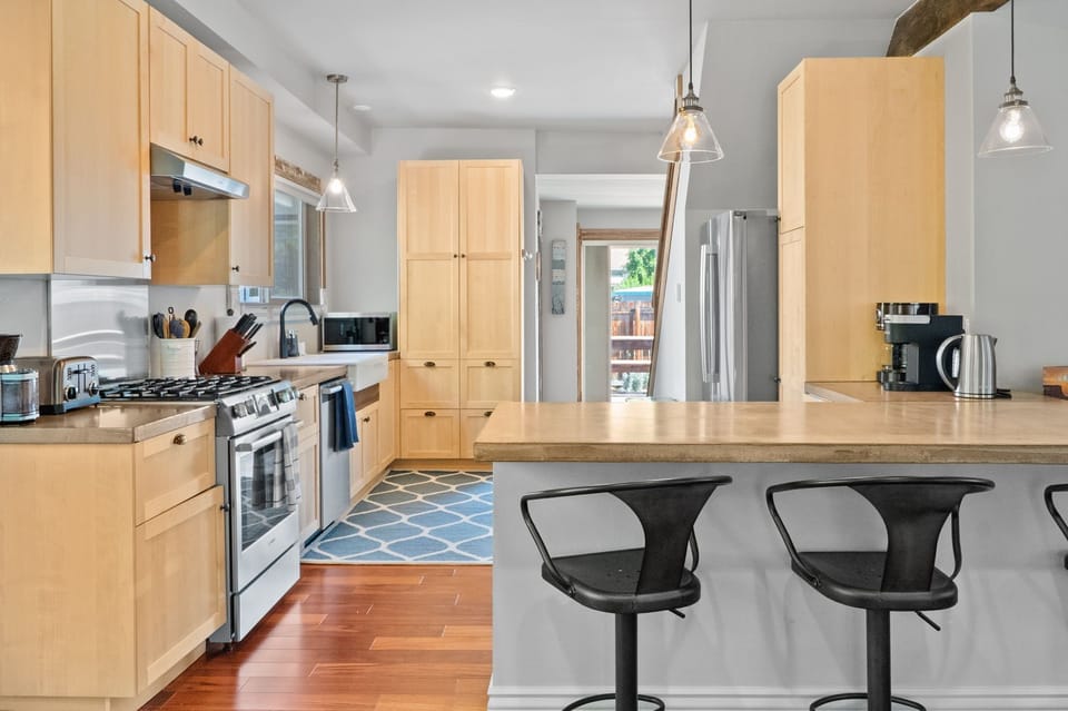 Amazing kitchen with high end Bosch appliances:  large refrigerator, gas stove, dishwasher, microwave, air fryer. 