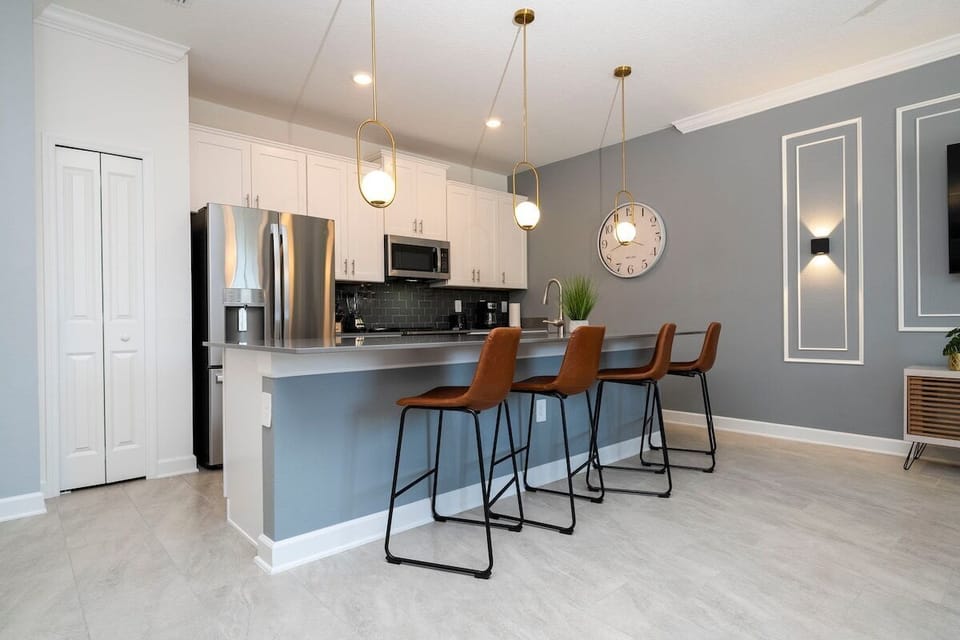 The fully equipped kitchen features modern appliances, sleek cabinetry, and all essential cookware and utensils, making it perfect for preparing meals with ease.