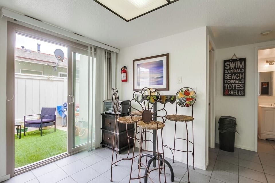Bistro table in kitchen for 4 guests with entrance to private patio
