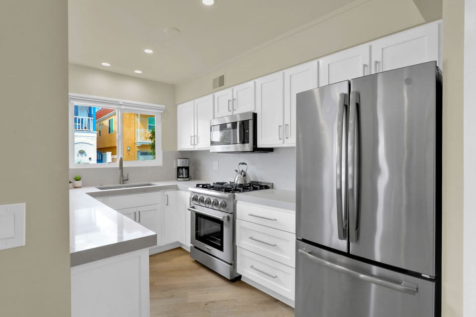 Full size kitchen with gas range & microwave.