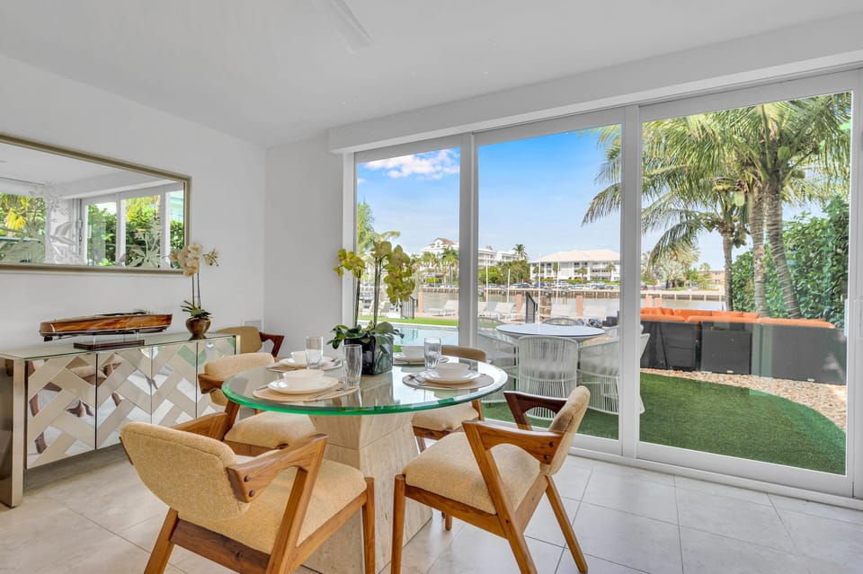 The dining table has seating for four and it overlooks the backyard.