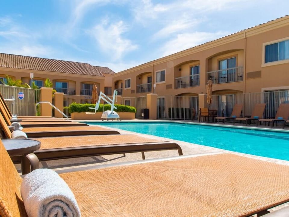 Soak up the sun on loungers beside the sparkling pool.
