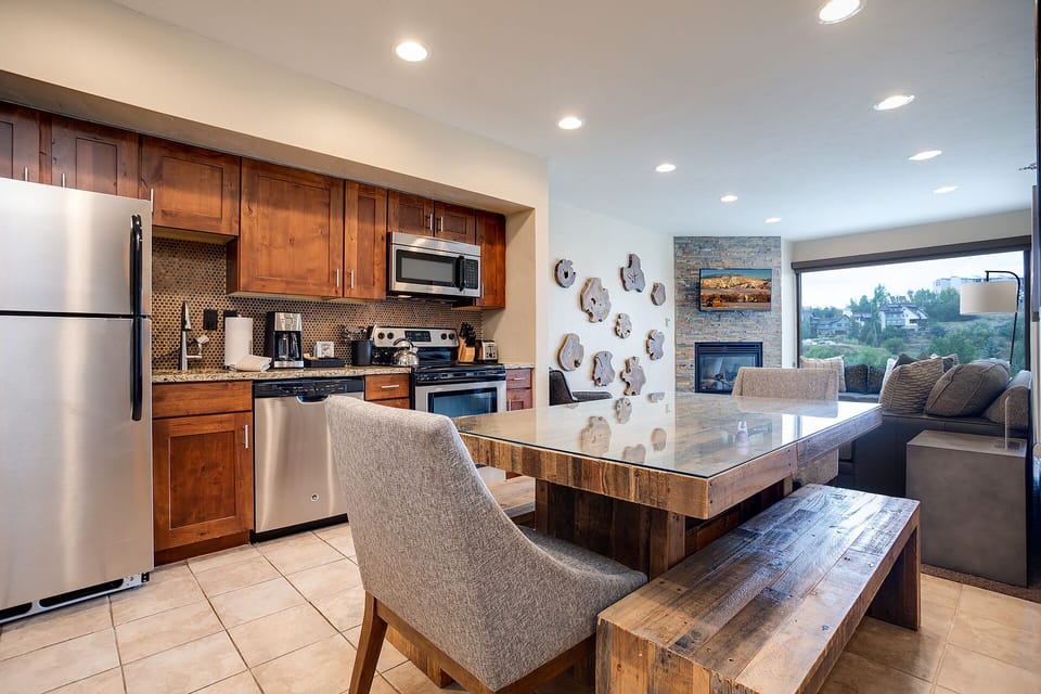 Your open-concept kitchen flows seamlessly into the living area, featuring warm wood cabinetry and modern appliances for effortless meal prep.