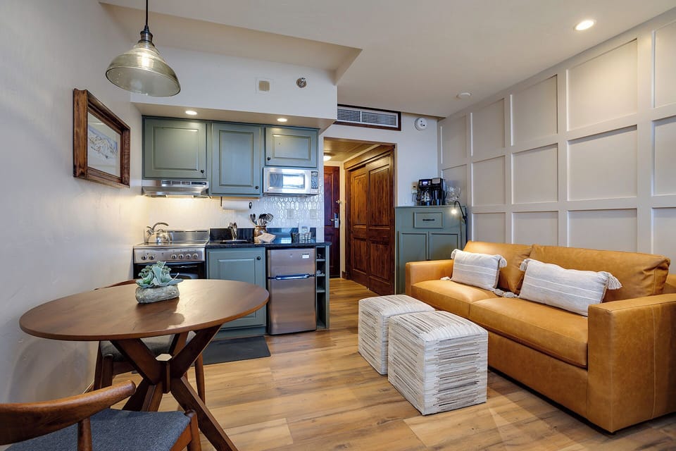 Unwind in your stylish open-plan retreat with cozy sofa, dining nook, and full kitchen ready for your culinary adventures.