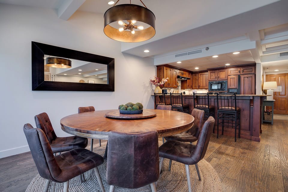 Gather around the handcrafted round table where your meals become memorable moments, with warm wood tones and elegant lighting creating the perfect dining atmosphere.