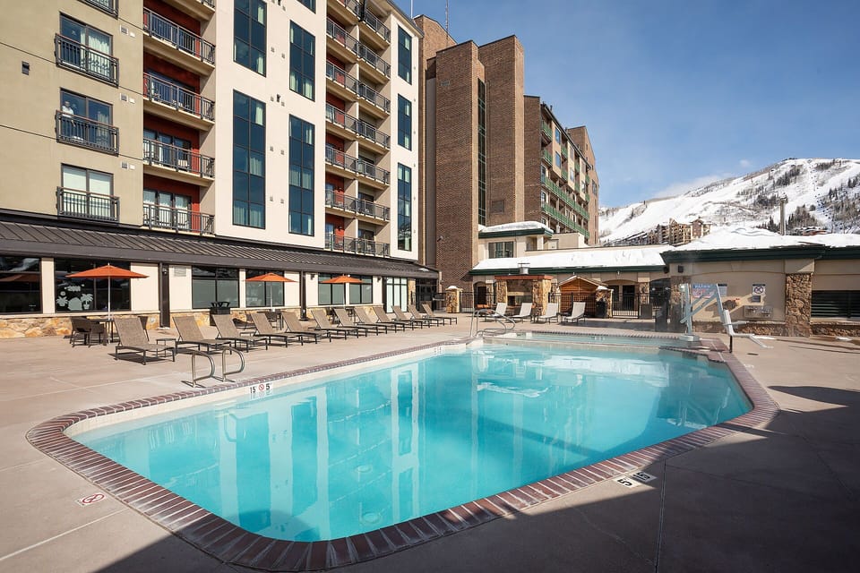 Modern mountain resort with heated outdoor pool, sunbeds, and scenic slopes nearby—perfect for a refreshing dip after a day on the mountain.