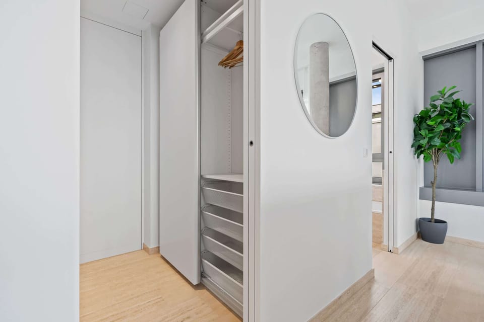 Ample storage in a sleek, modern closet to make yourself at home.