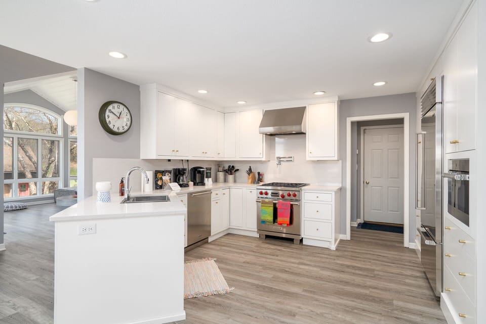 Cook with ease in this bright, fully-equipped kitchen featuring stainless steel appliances and ample counter space for meal prep.