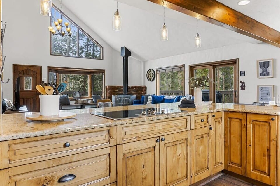 The view over the kitchen bar into the living room. The open floor plan makes it easy to stay social with your group from everywhere in this space.