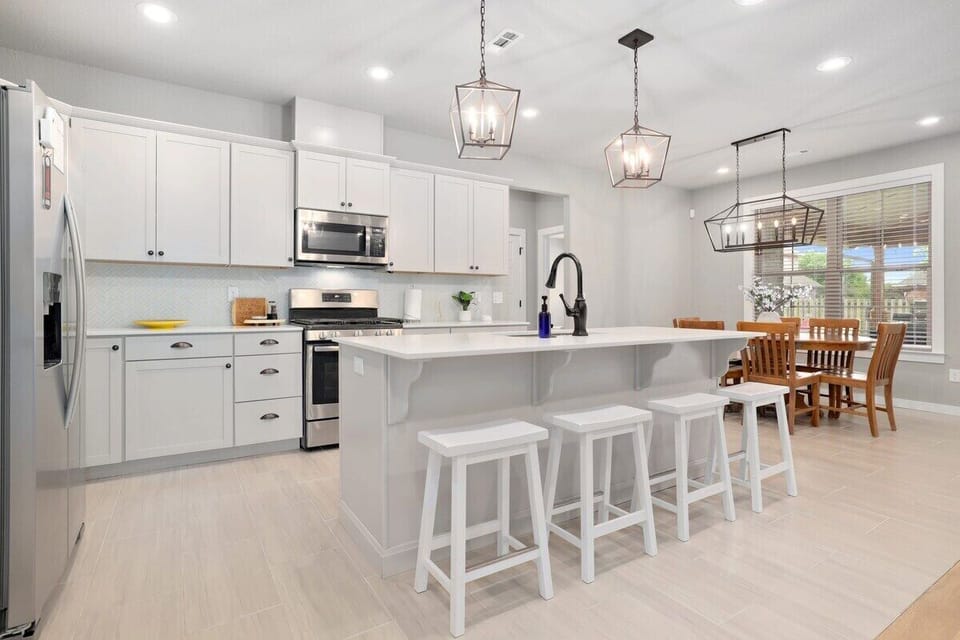 To the left, you'll find a fully stocked kitchen, featuring state-of-the-art appliances and all the necessary amenities for cooking, baking and making that perfect cup of coffee.