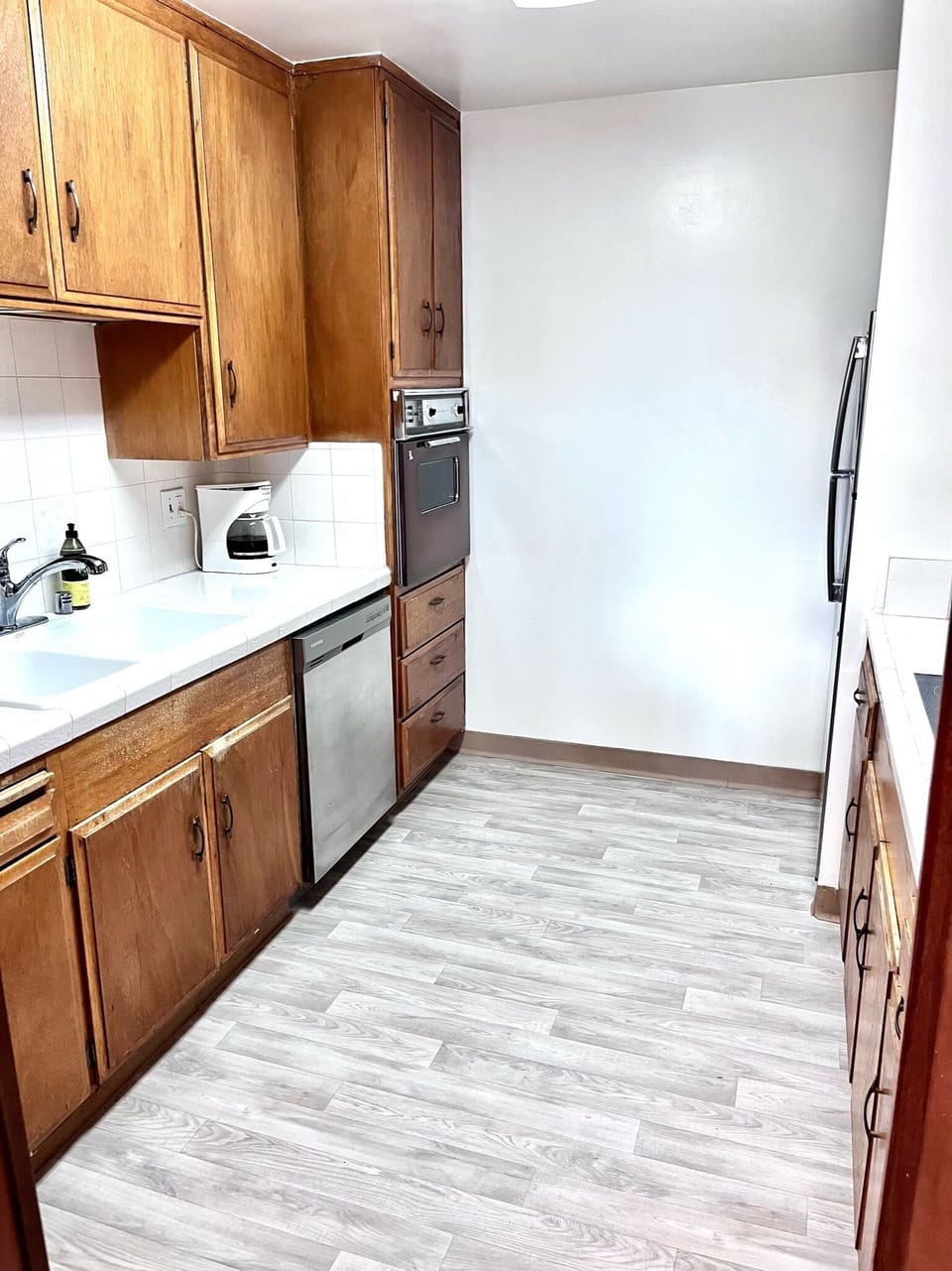 Kitchen fully equipped with pots, pans, utensils and appliances