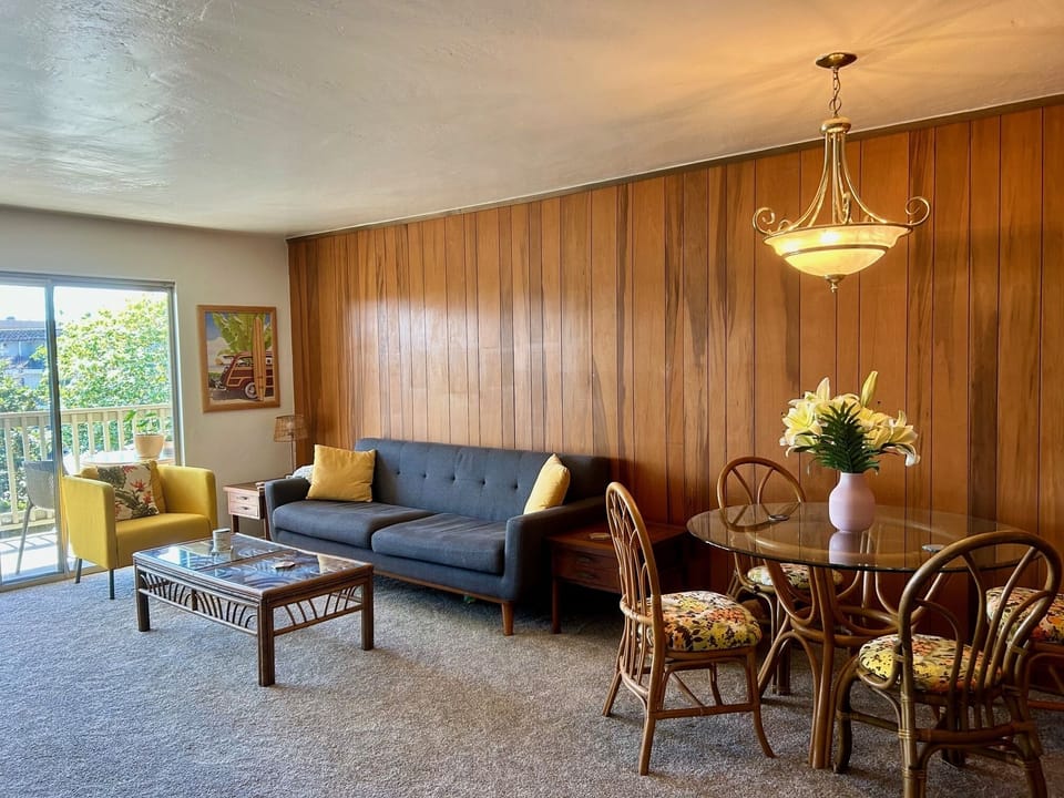Comfortable sunny living room with original wood paneling