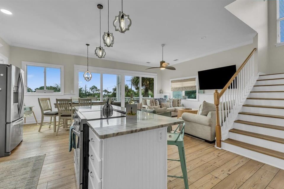 kitchen view into the living room with a 16 foot sliding glass door to the balcony 