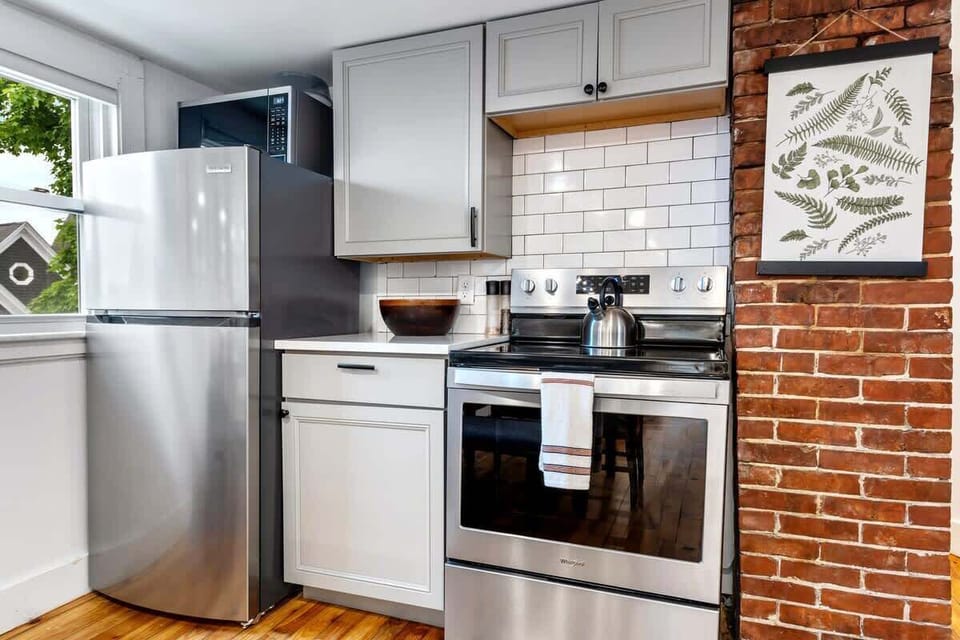 The kitchen includes a full-size refrigerator, oven, gas stove and microwave 
