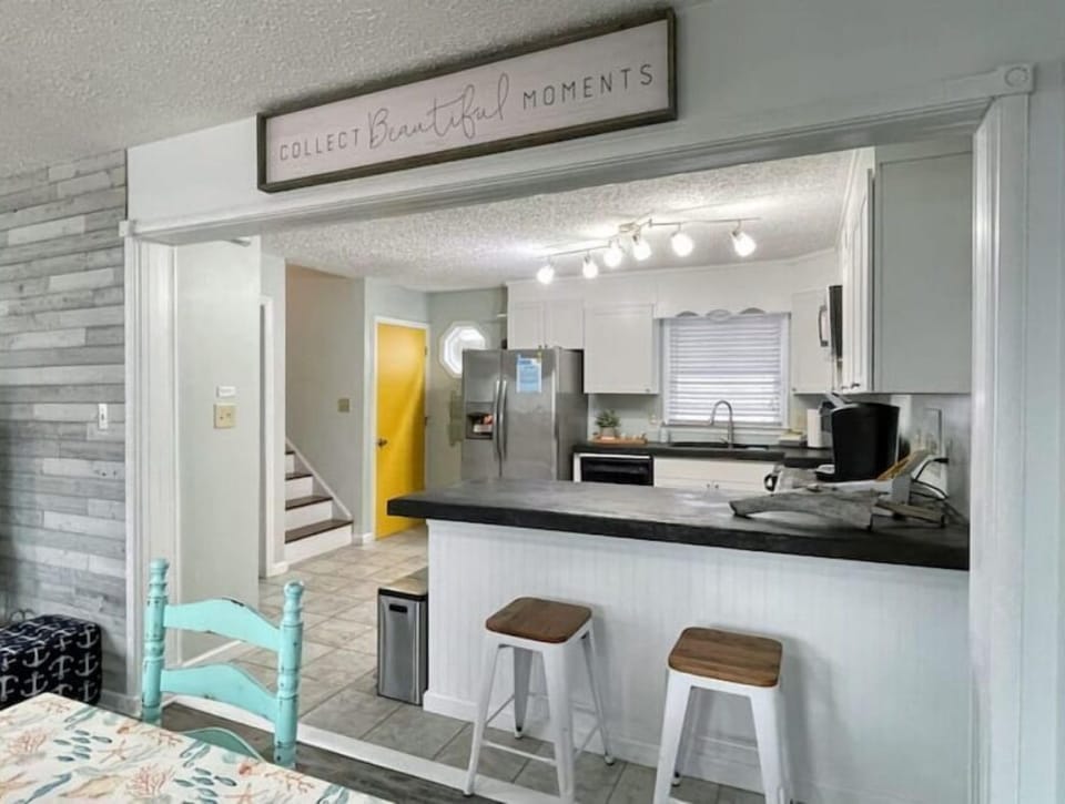 Countertop seating overlooking the large kitchen.