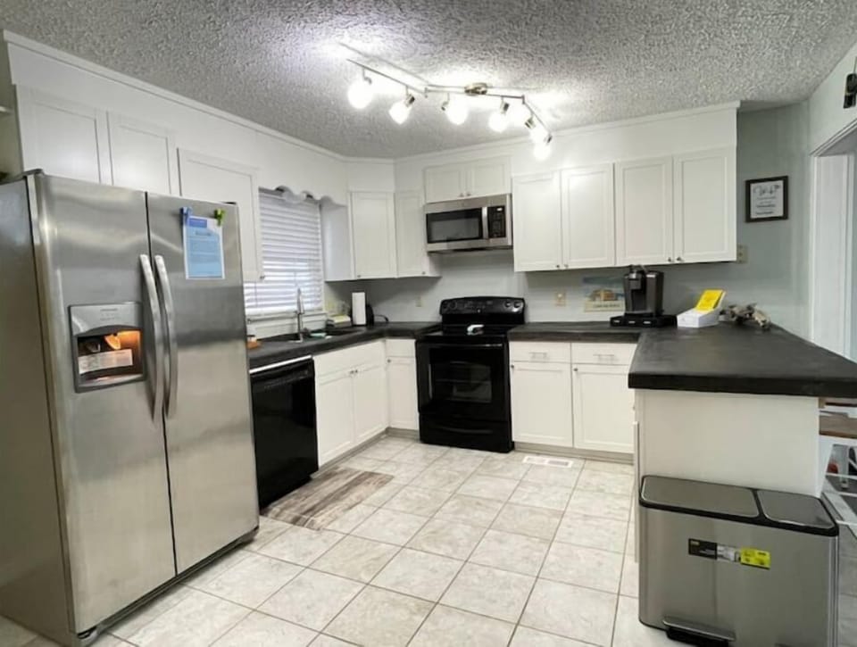 Fully stocked kitchen + griddle, blender, coffee maker, plates/bowls, & more.