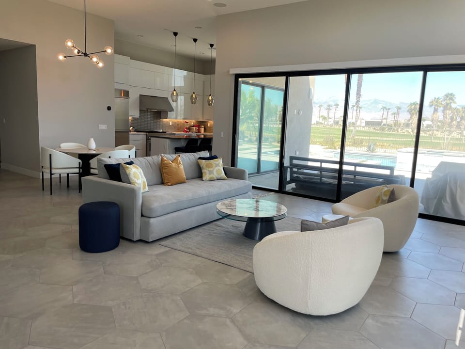 Great room, comfortable seating; folding patio doors to covered patio