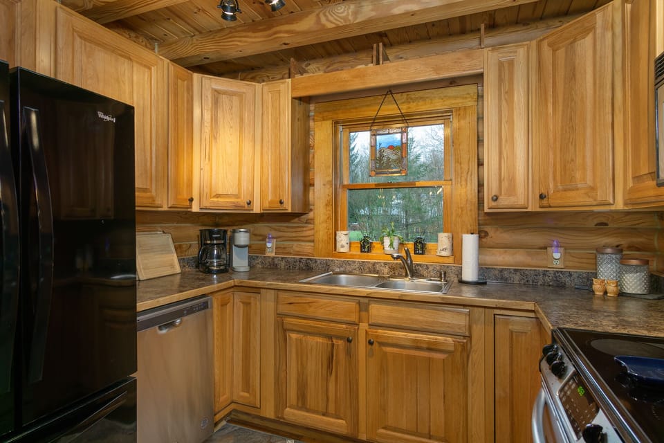 Kitchen with dishwasher, coffee grinder, and two types of coffeemakers (Keurig & standard drip).