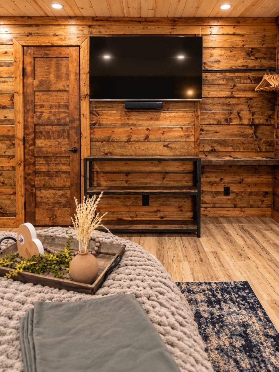 Cozy Rustic Cabin Bedroom with Mounted TV