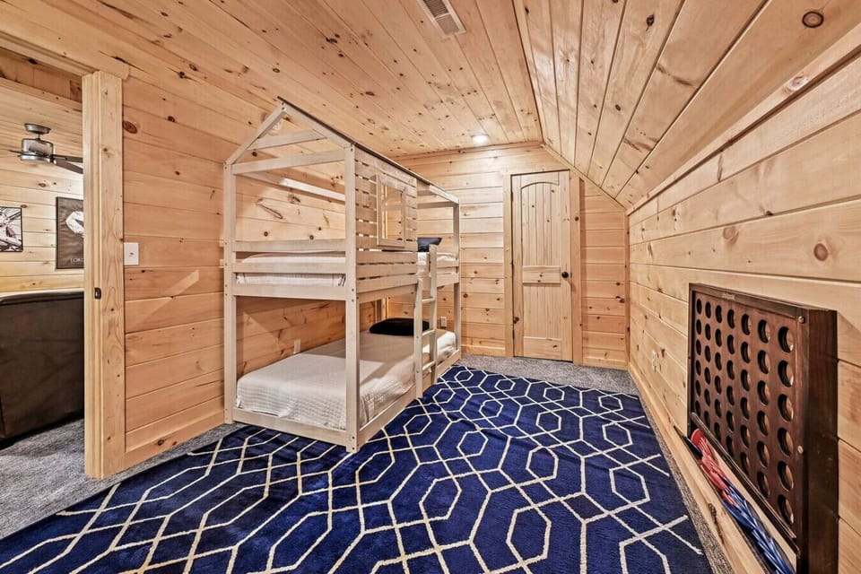 Full/full bunk beds located in the bedroom just outside the living area. The bedroom also includes a Connect 4 wall game for additional entertainment.
