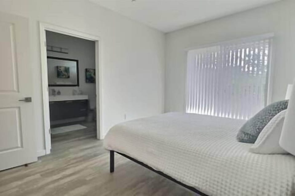 Master suite with queen bed, ensuite bath, and patio access with beautiful olive orchard views.