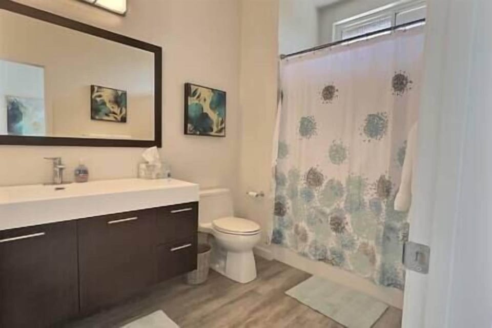 Private master bath with large vanity and shower, stocked with essentials for a spa-like retreat.