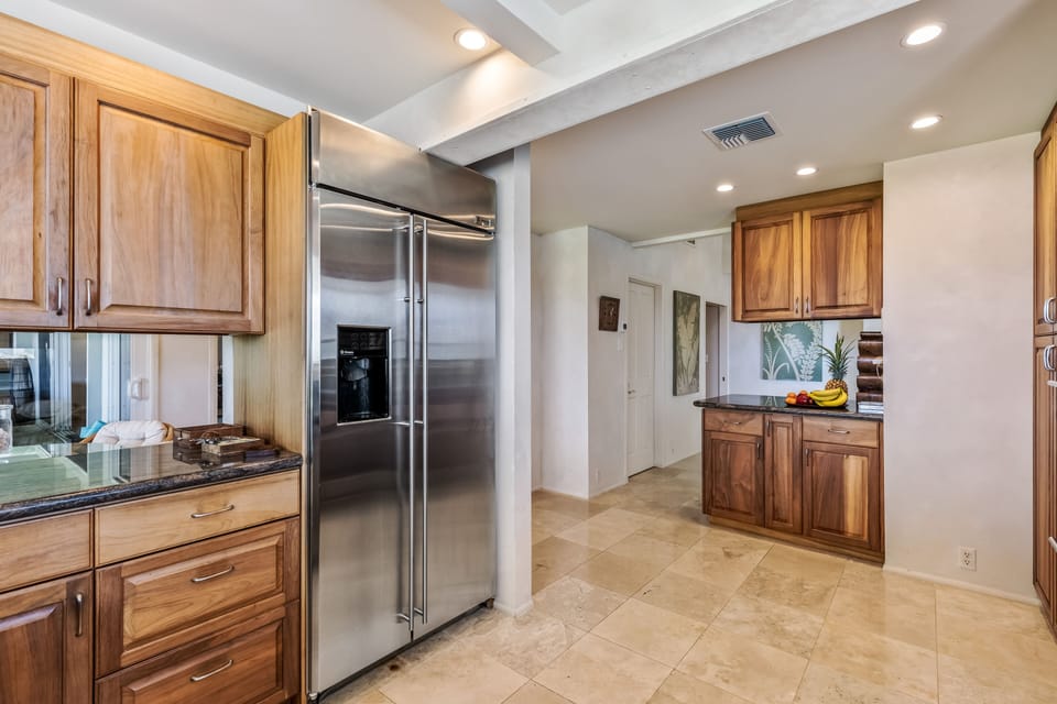 Spacious kitchen includes multiple refrigerators and abundant storage—ideal for large groups or long stays.