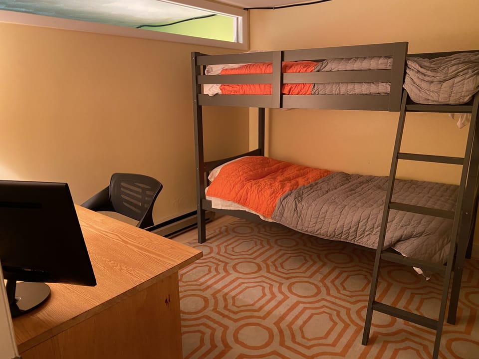 Bonus bedroom in the basement level has twin-sized bunk beds and a desk.