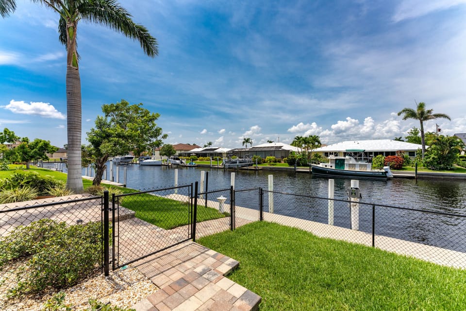 Tarpon Inlet Canal with fenced yard and large dock!  
