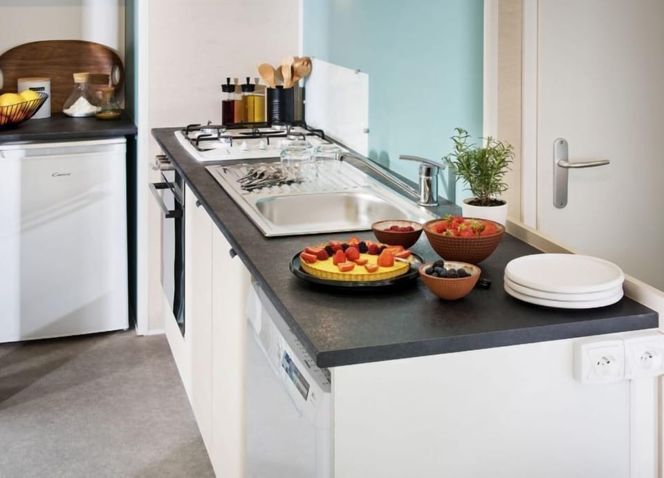 This stylish kitchen area, equipped with contemporary appliances, invites families to prepare delicious meals in comfort and convenience.