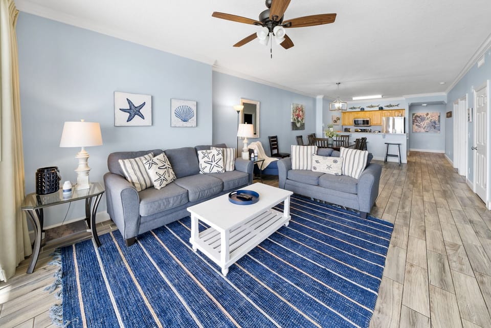 Unwind in your coastal-themed living space with plush seating, nautical touches, and an open layout that flows into the fully equipped kitchen.