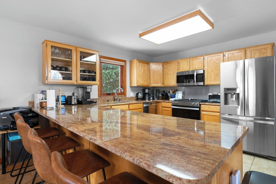 Your spacious kitchen features granite countertops, stainless steel appliances, and a breakfast bar where you can enjoy morning coffee.