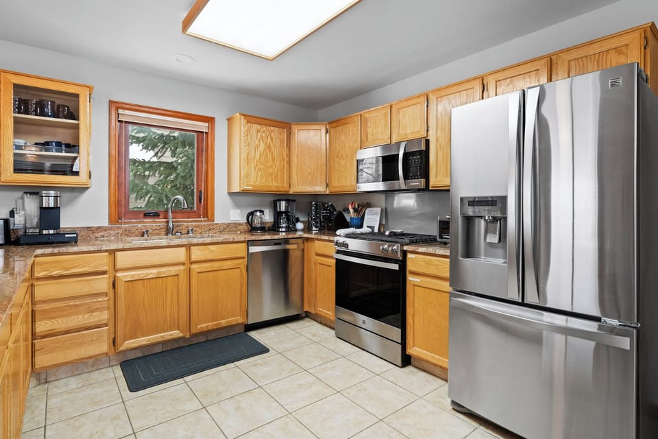 Cook your favorite meals in this fully-equipped kitchen featuring stainless steel appliances, granite countertops, and plenty of cabinet space for all your culinary needs.