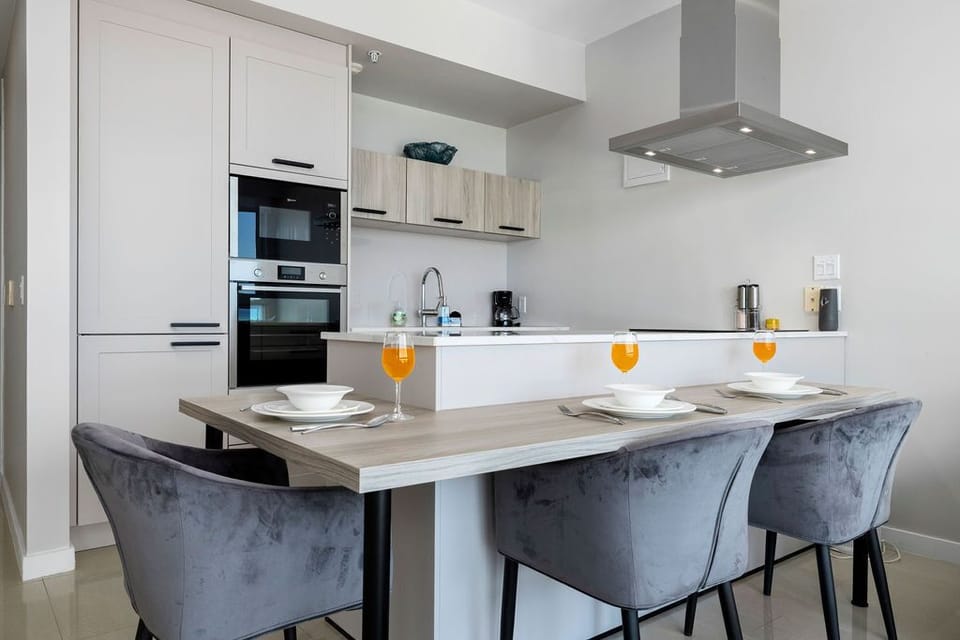 Your fully equipped kitchen awaits, complete with modern appliances and a stylish dining table set for memorable meals with loved ones.