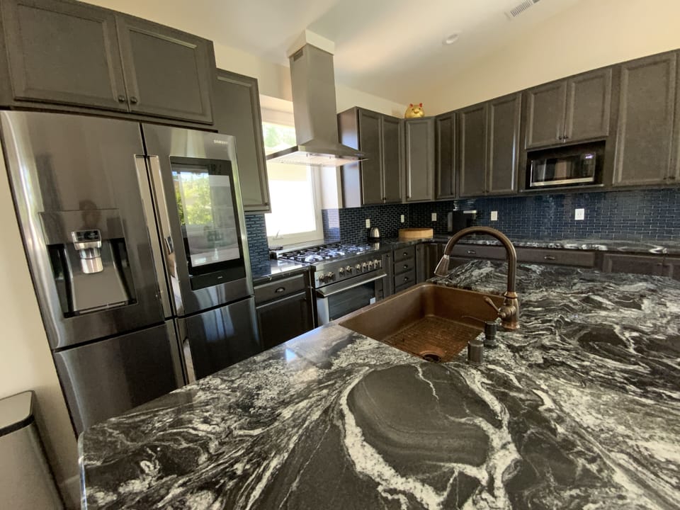 Huge Intergalactic-looking Granite countertops. Beautiful copper sink