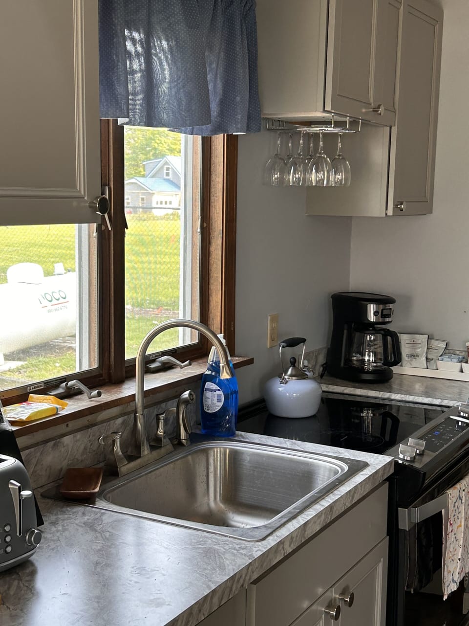 Full kitchen with stove, microwave, roaster and coffee maker