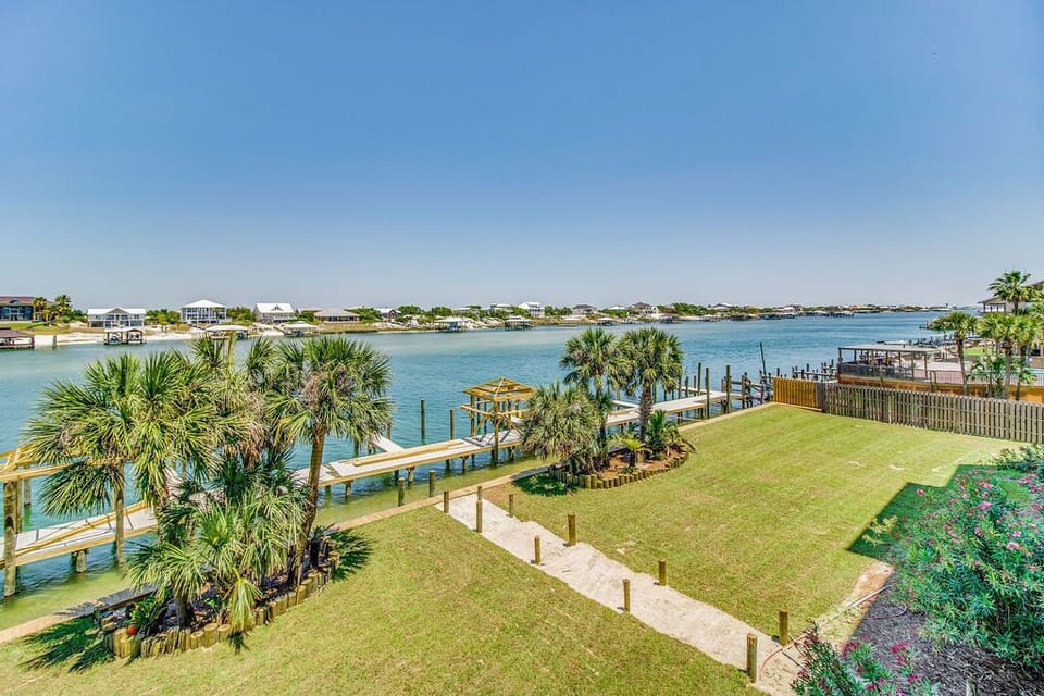 Wind Drift Orange Beach grounds with green space and Old River waterfront access