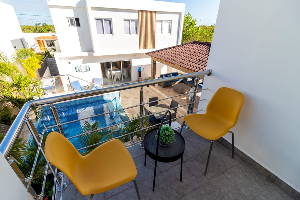The bedroom offers direct access to a balcony with a view of the surroundings