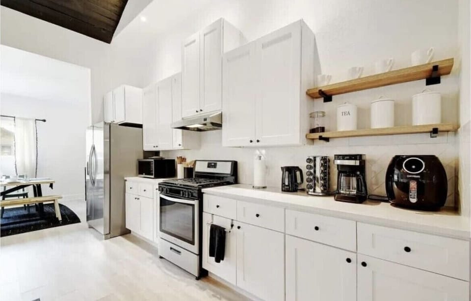 Open concept kitchen w/stainless steel stove/oven and full size frig