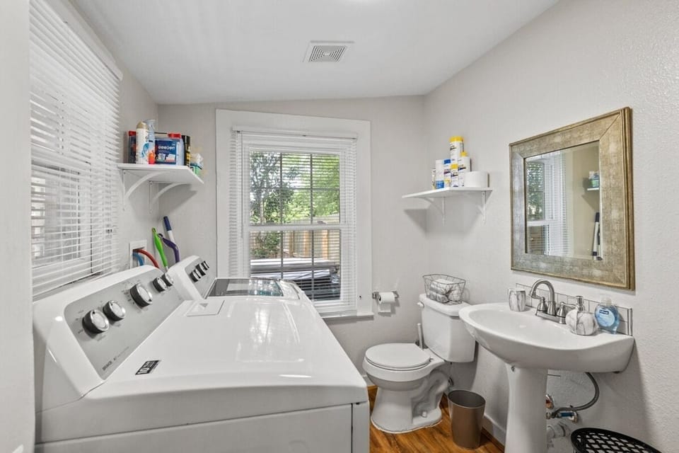 Full size washer/dryer and 1/2 bath in this laundry room space.