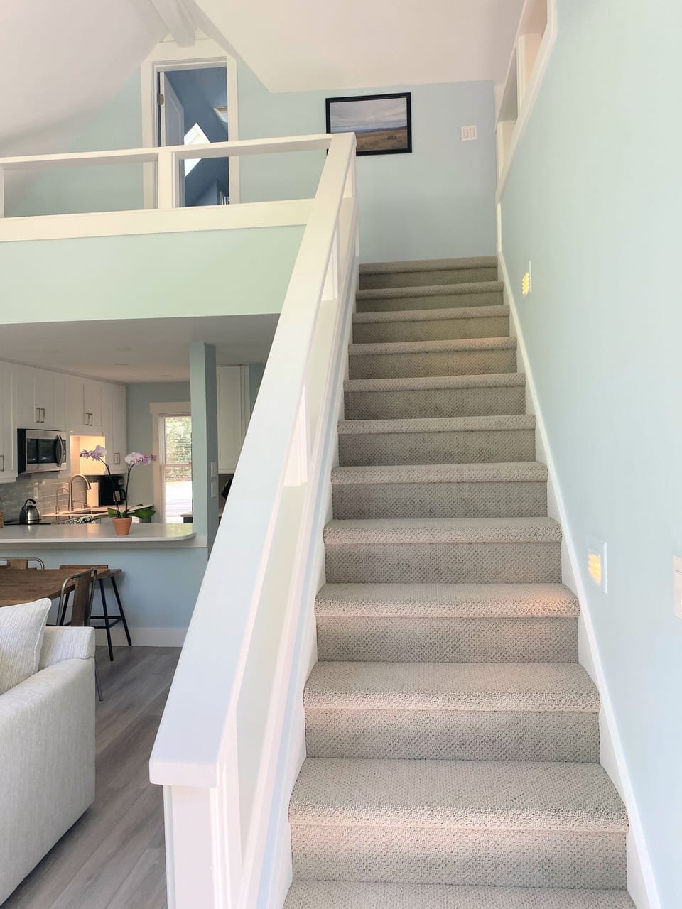 Stairs to loft queen bedroom & bathroom, fully carpeted with lighting and handrail