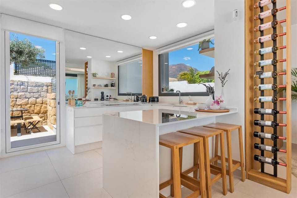 Modern kitchen is fully equipped with all the appliances and breakfast bar 