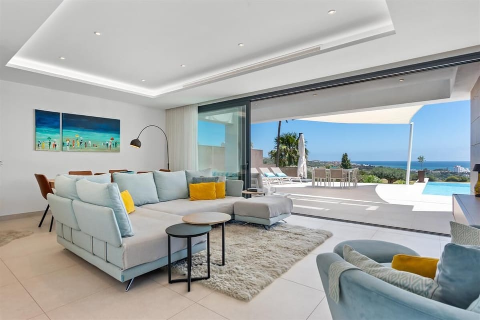 Bright and stylish lounge area with comfortable seating and sea views