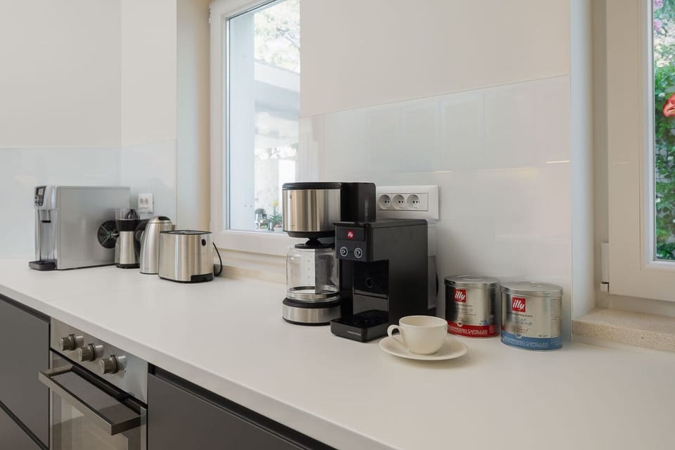 coffee machine with coffe among other kitchen appliances on the counter in the kitchen of the modern villa Sutivan Infinity with pool and sea view